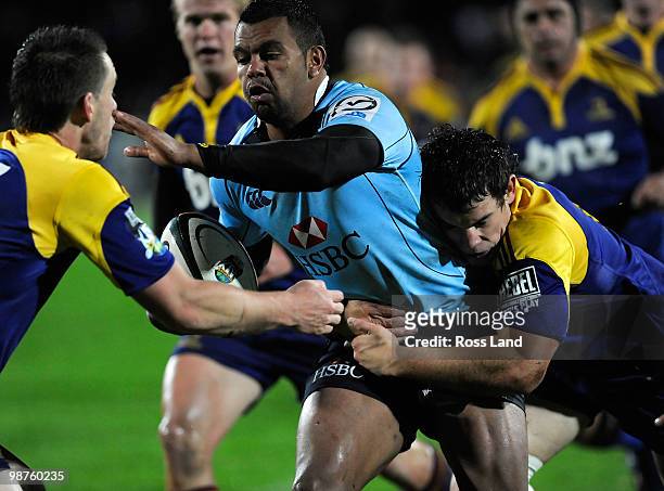 Kurtley Beale of the Waratahs runs at the Highlanders defence during the round 12 Super 14 match between the Highlanders and the Waratahs on April...