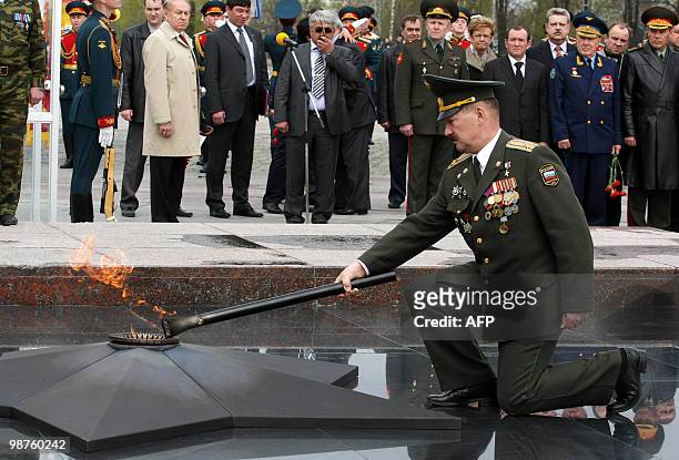 Russian officer Vyacheslav Sivko lights the "Eternal Flame of Memory and Glory" at Victory Park in Moscow on April 30, 2010. In the run up to 65th...
