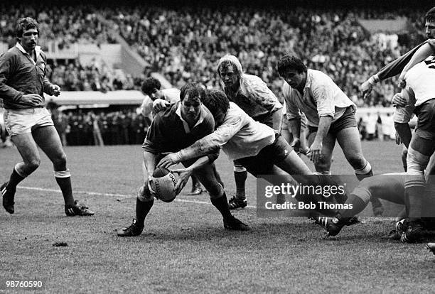 Terry Holmes of Wales is tackled by Jean-Luc Joinel of France during the Rugby Union International match held at the Parc des Princes, Paris on 19th...