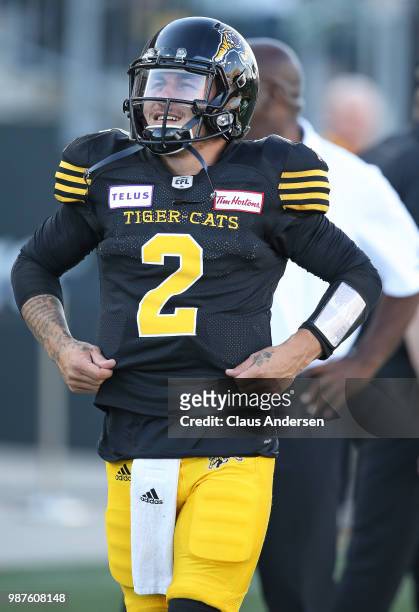 Johnny Manziel of the Hamilton Tiger-Cats stands on the sidelines prior to action against the Winnipeg Blue Bombers in a CFL game at Tim Hortons...