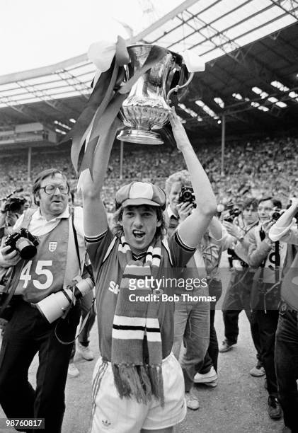 Jesper Olsen of Manchester United holds the FA Cup aloft during the lap of honour after his team's victory over Everton in the FA Cup Final held at...