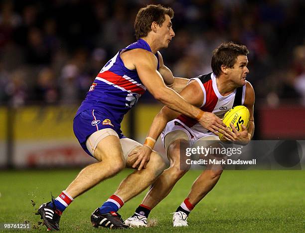 Dale Morris of the Bulldogs tackles Adam Schneider of the Saints during the round six AFL match between the Western Bulldogs and the St Kilda Saints...