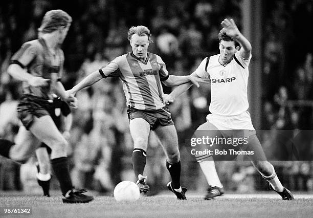 Arthur Graham of Bradford City holds off a challenge from Norman Whiteside of Manchester United during a Charity Game held at the Leeds Road Stadium,...