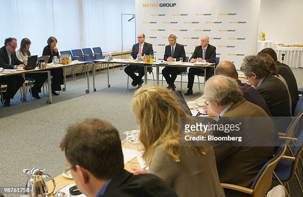 Eckhard Cordes, chief executive officer of Metro AG, center, speaks as Olaf Koch, the company's chief financial officer, right, and Michael Inacker,...