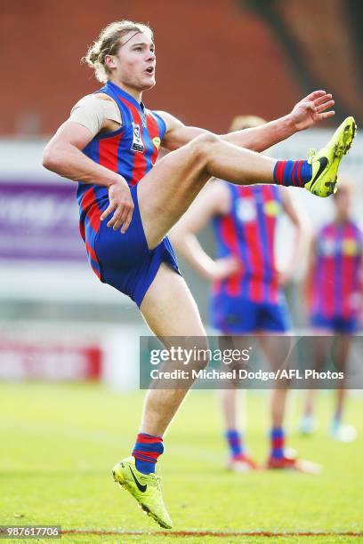 Tom Hobbs of Port Melbourne kicks the ball for a goal during the round 13 VFL match between Port Melbourne and Sandringham at North Port Oval on June...