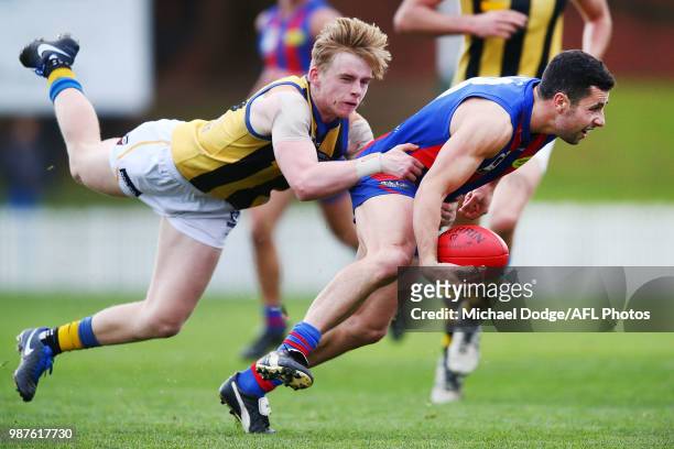 Ed Phillips of Sandringham tackles Mitch Wooffindin of Port Melbourne during the round 13 VFL match between Port Melbourne and Sandringham at North...