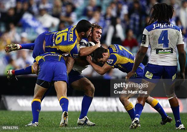 Gary Warburton of the Bulldogs is tackled by Justin Horo of the Eels during the round eight NRL match between the Parramatta Eels and the...