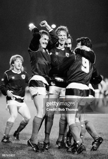 Kenny Dalglish of Scotland leads the celebration with Gordon Strachan, Alex McLeish, Willie Miller and Davie Cooper congratulating Frank McAvennie...