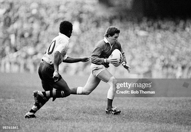 Jonathon Davies of Wales moves past Acura Niuqila of Fiji during the Rugby Union International match held at Cardiff Arms Park on 9th November 1985....