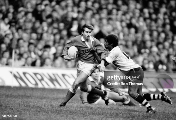 Mark Titley of Wales is held by Fiji centre Tomasi Cama during the Rugby Union International match held at Cardiff Arms Park on 9th November 1985....
