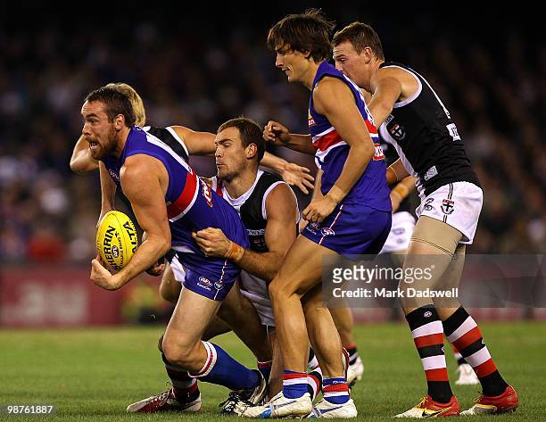 Ben Hudson of the Bulldogs handballs out of a pack during the round six AFL match between the Western Bulldogs and the St Kilda Saints at Etihad...