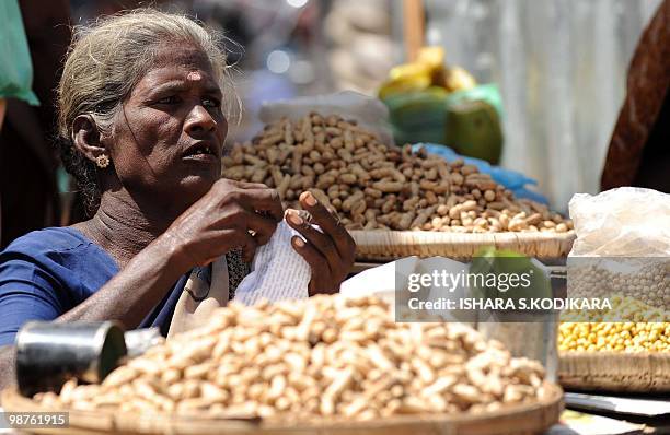 Sri Lankan woman sells nuts in the northern town Jaffna on April 30, 2010. The Central Bank opened two financial company branches as part of the...