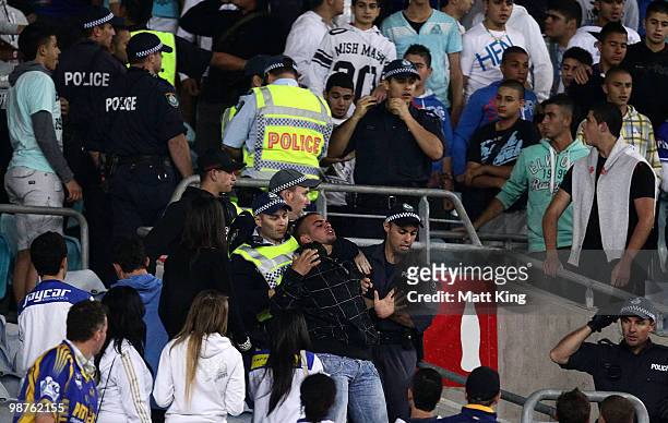 Fans are held by police after a brawl broke out during the round eight NRL match between the Parramatta Eels and the Canterbury-Bankstown Bulldogs at...