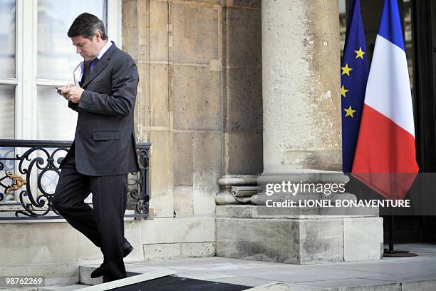 Elysee communication adviser Franck Louvrier looks at his phone prior to a working lunch between French President Nicolas Sarkozy and European...