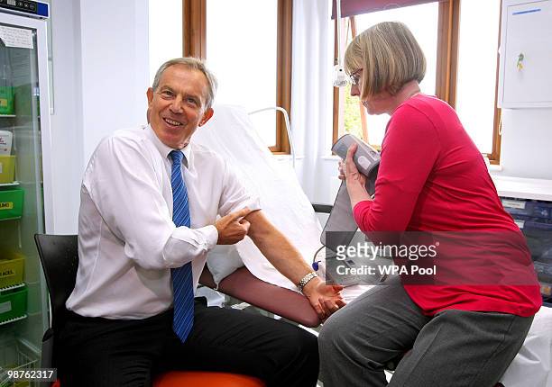 Former Prime Minister Tony Blair has his blood pressure taken by Nurse Paula Martin during a visit to Alexandra Avenue Health and Social Care Centre...