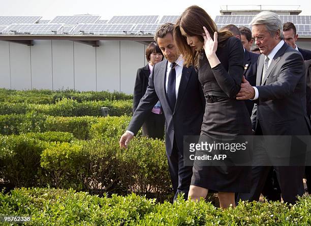 French President Nicolas Sarkozy , his wife Carla Bruni-Sarkozy and French actor Alain Delon walk in the French pavilion, during a visit at the...