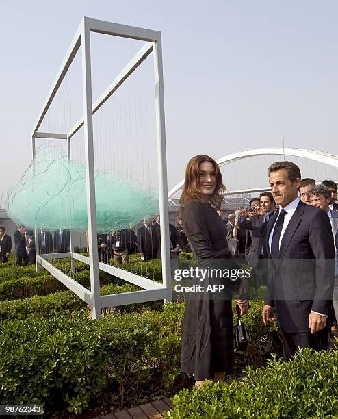 French President Nicolas Sarkozy and his wife Carla Bruni-Sarkozy walk in the French pavilion, during a visit at the Shanghai World Expo site in...