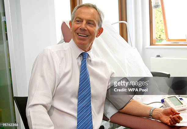 Former Prime Minister Tony Blair has his blood pressure taken by Nurse Paula Martin during a visit to Alexandra Avenue Health and Social Care Centre...