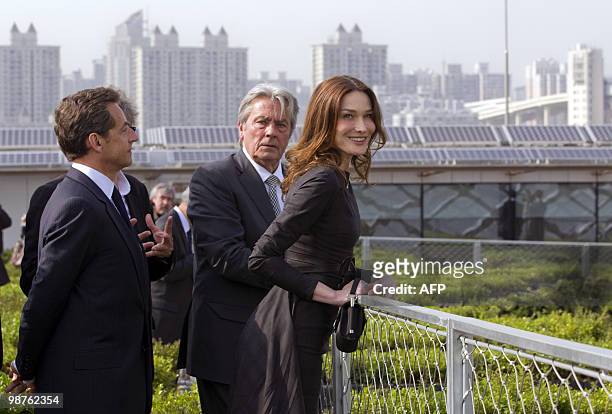 France's President Nicolas Sarkozy , his wife Carla Bruni-Sarkozy and French actor Alain Delon are pictured in the French pavilion, during a visit at...