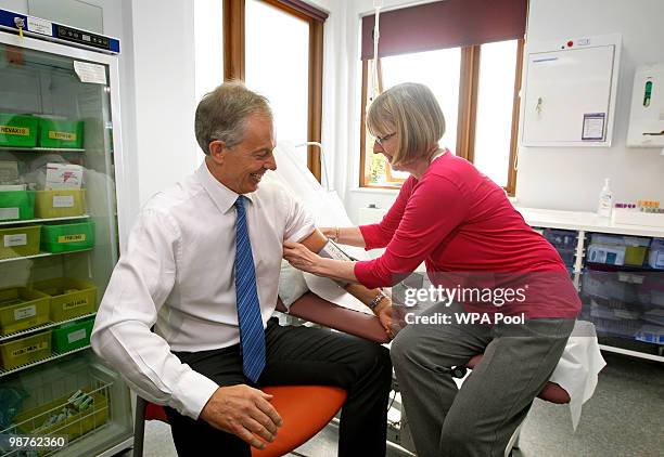 Former Prime Minister Tony Blair has his blood pressure taken by Nurse Paula Martin during a visit to Alexandra Avenue Health and Social Care Centre...