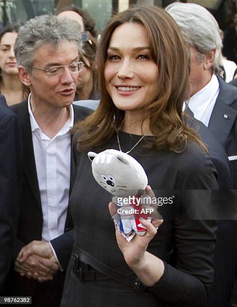 French First lady Carla Bruni-Sarkozy holds a mascot of the French pavilion as she walks in the French pavilion, during a visit at the Shanghai World...