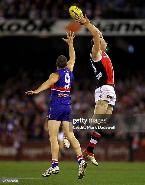 Lindsay Gilbee of the Bulldogs attempts to spoil Brendon Goddard of the Saints during the round six AFL match between the Western Bulldogs and the St...