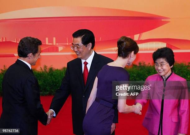 French President Nicolas Sarkozy and his wife Carla Bruni-Sarkozy shake hands with Chinese President Hu Jintao and his wife Liu Yongqing at a...
