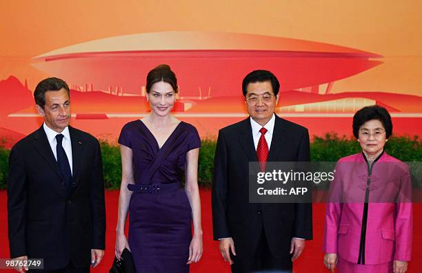 French President Nicolas Sarkozy and his wife Carla Bruni-Sarkozy stand with Chinese President Hu Jintao and his wife Liu Yongqing at a welcoming...