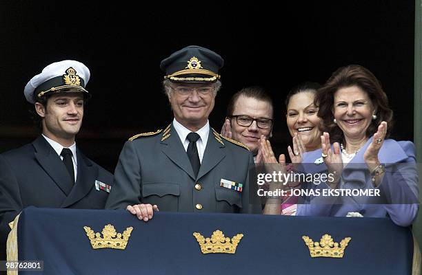 Swedish King Carl Gustaf, , smiles, surrounded by Prince Carl Philip, , Queen Silvia , Crown Princess Victoria, and her fiance Daniel Westling , at...