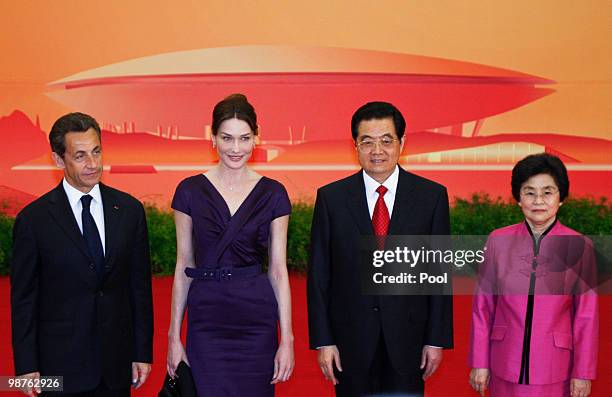 French President Nicolas Sarkozy and his wife Carla Bruni-Sarkozy with Chinese President Hu Jintao, and his wife Liu Yongqing stand for photos during...