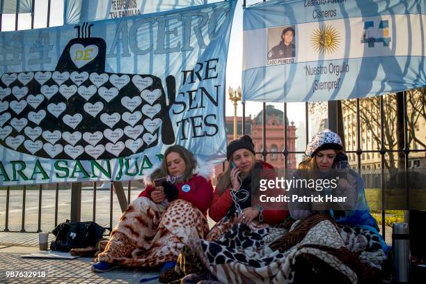 Relatives of the ARA San Juan crew with hands chained look on during a protest in front of the Casa Rosada demanding the government to continue the...