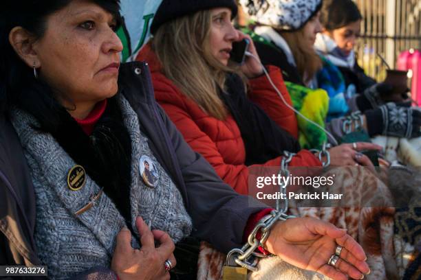 Relatives of the ARA San Juan crew with hands chained look on during a protest in front of the Casa Rosada demanding the government to continue the...