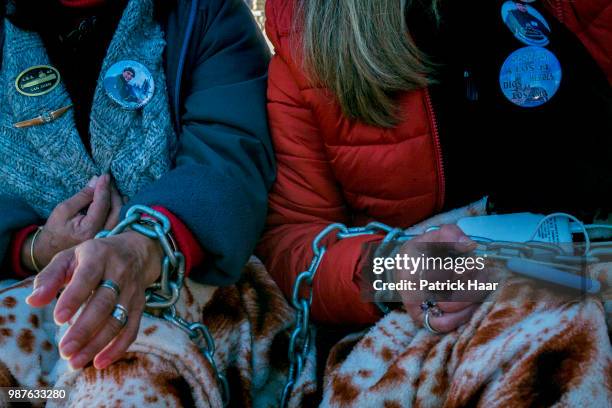 View of hands chained of two relatives of the ARA San Juan crew during a protest in front of the Casa Rosada demanding the government to continue the...