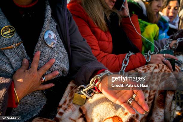 Relatives of the ARA San Juan crew with hands chained look on during a protest in front of the Casa Rosada demanding the government to continue the...