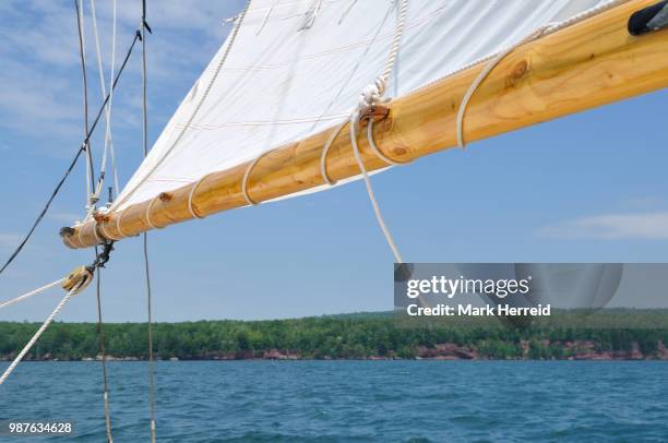 boom and foresail of schooner sailboat - sail boom stock-fotos und bilder