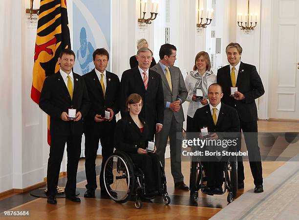 German President Horst Koehler and German Defense Minister Karl-Theodor zu Guttenberg pose with Viktoria Rebensburg , Anna Schaffelhuber , Martin...