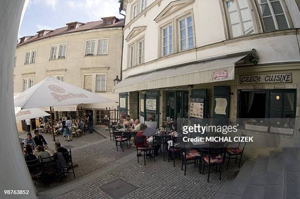 Tourists have a drink at the gardens of restaurants on April 30, 2010 near Prague Castle. AFP PHOTO / MICHAL CIZEK