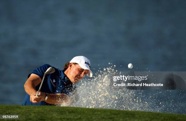 Phil Mickelson plays from a greenside bunker on the 14th during the second round of the Quail Hollow Championship at Quail Hollow Country Club on...