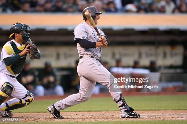 Jorge Posada of the New York Yankees hitting during the game against the Oakland Athletics at the Oakland Coliseum on April 21, 2010 in Oakland,...