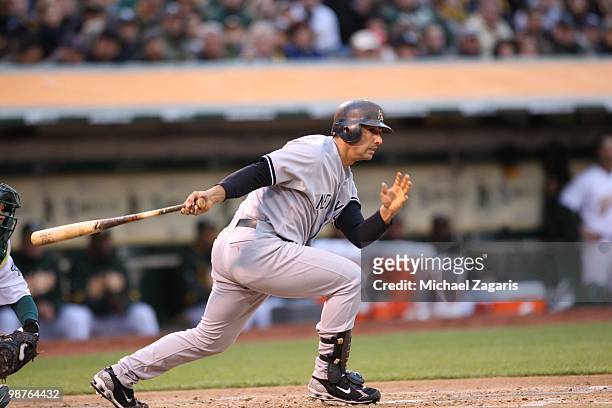 Jorge Posada of the New York Yankees hitting during the game against the Oakland Athletics at the Oakland Coliseum on April 21, 2010 in Oakland,...