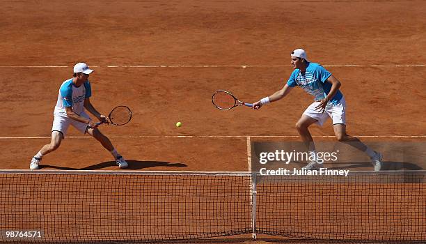 John Isner and Sam Querrey of USA in action in their doubles match against Yves Allegro and Roger Federer of Switzerland during day six of the ATP...