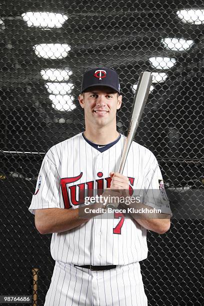 Joe Mauer of the Minnesota Twins poses with his 2009 AL Batting Champion Award near the batting cages prior to the game with the Cleveland Indians on...