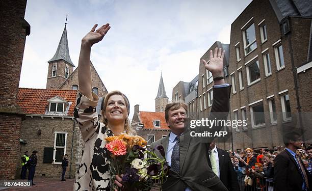 Prince Willem Alexander and Princess Maxima wave to the crowd during the celebration of Queensday in Middelburg, Netherlands 0n April 30, 2010. AFP...