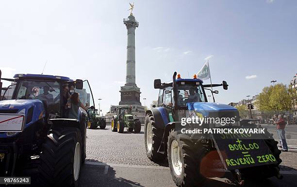 French farmers drive their tractors around the place de la Bastille on April 27, 2010 in Paris, as they demonstrate against wages cut and to denounce...