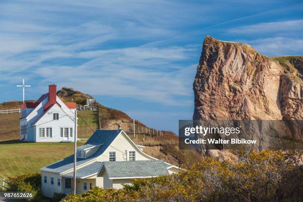 quebec, gaspe peninsula, perce, village buildings and perce rock - perce rock stock pictures, royalty-free photos & images