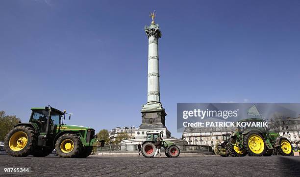 French farmers drive their tractors around the place de la Bastille on April 27, 2010 in Paris, as they demonstrate against wages cut and to denounce...
