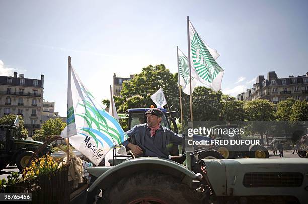 French farmers demonstrate with their tractors on April 27, 2010 in Paris to protest against wages cut and to denounce the European Farm Policy. The...