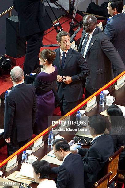 Nicholas Sarkozy, France's president, center, adjusts his coat, during the opening ceremony of the 2010 World Expo in Shanghai, China, on Friday,...