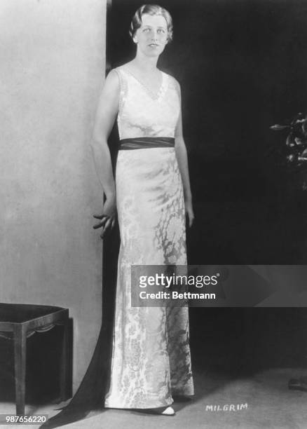 Anna Roosevelt Dall, daughter of president-elect and Mrs. Eleanor Franklin, pictured in the red and white Sally Milgrim gown she will be wearing at...