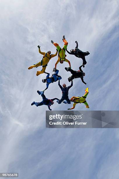 formation divers holding grips in the sky. - saanen stock pictures, royalty-free photos & images